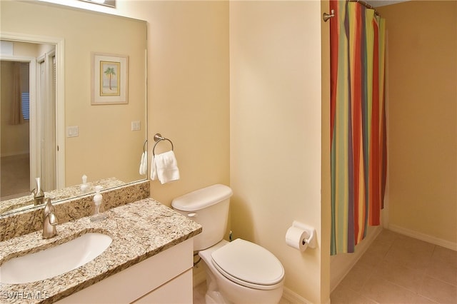 bathroom with vanity, toilet, and tile patterned floors