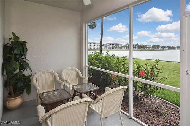 sunroom / solarium with a water view