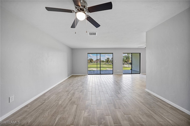 spare room featuring light hardwood / wood-style flooring and ceiling fan