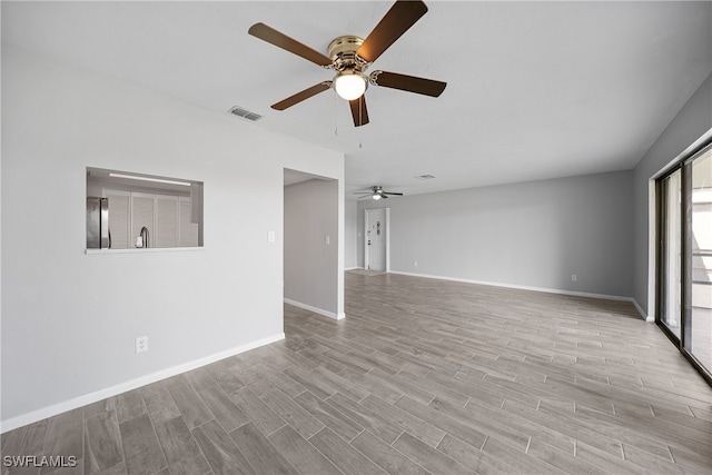 unfurnished living room featuring light wood-type flooring and ceiling fan