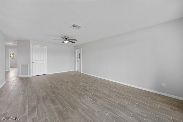 spare room with light wood-type flooring and ceiling fan