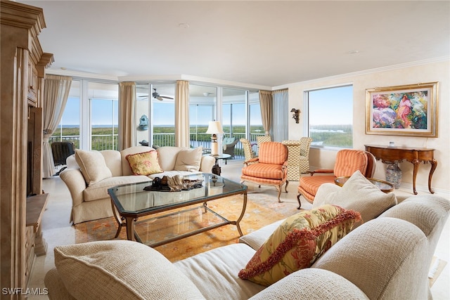 living room with a water view, ornamental molding, plenty of natural light, and ceiling fan