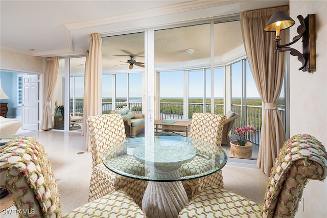 sunroom / solarium featuring ceiling fan