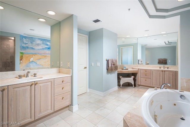 bathroom with vanity, tiled tub, and tile patterned flooring