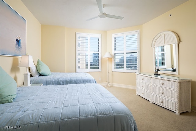 bedroom with light carpet and ceiling fan