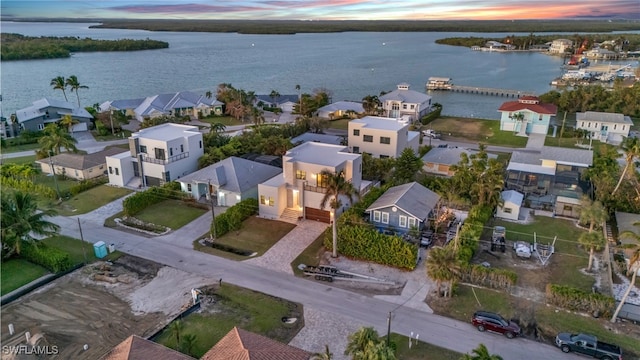 birds eye view of property featuring a water view and a residential view