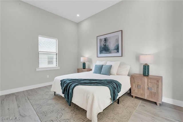 bedroom featuring recessed lighting, light wood-type flooring, and baseboards