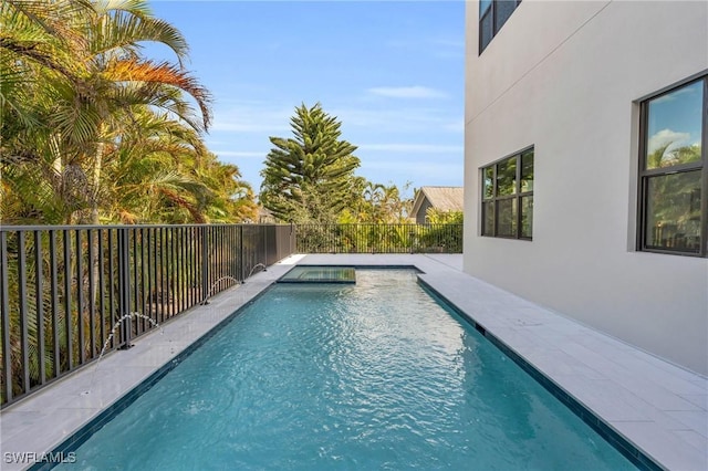 view of swimming pool with a fenced in pool and fence