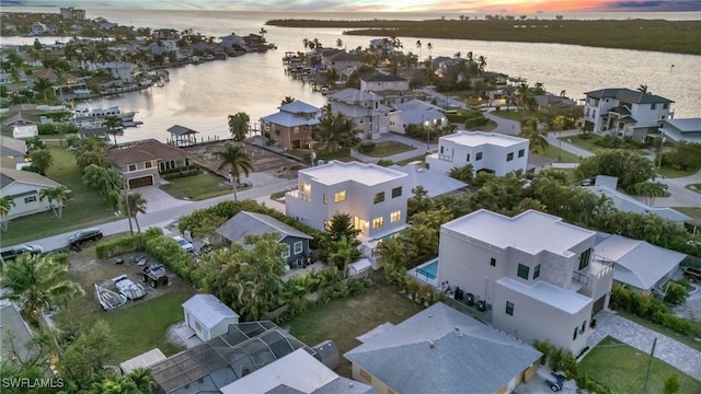 birds eye view of property with a water view and a residential view