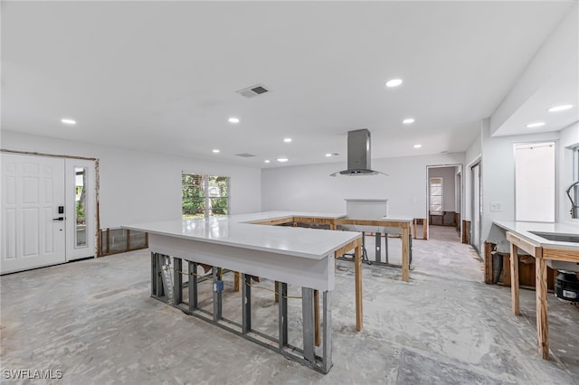 2472 Harbor Rd, Naples, FL 34104 - kitchen with island exhaust hood, recessed lighting, concrete floors, a spacious island, and a sink