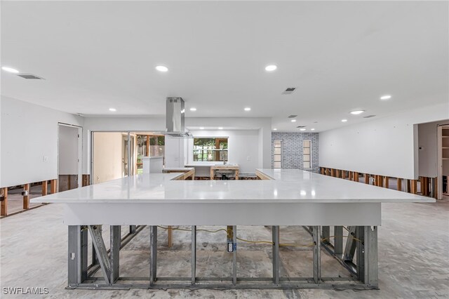 2472 Harbor Rd, Naples, FL 34104 - kitchen with island exhaust hood, light countertops, recessed lighting, a spacious island, and a kitchen bar