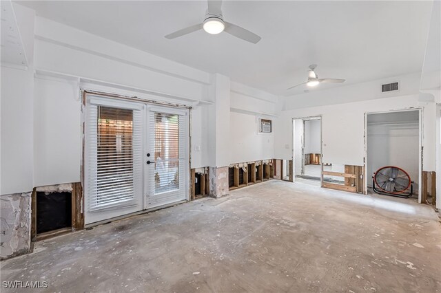 unfurnished living room with ceiling fan and french doors