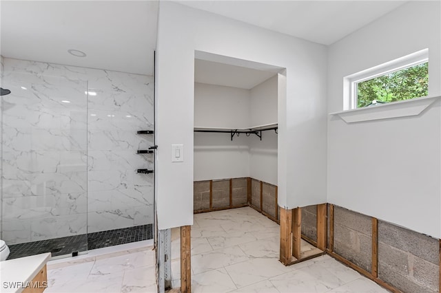 2472 Harbor Rd, Naples, FL 34104 - full bath featuring marble finish flooring, a marble finish shower, a walk in closet, and toilet
