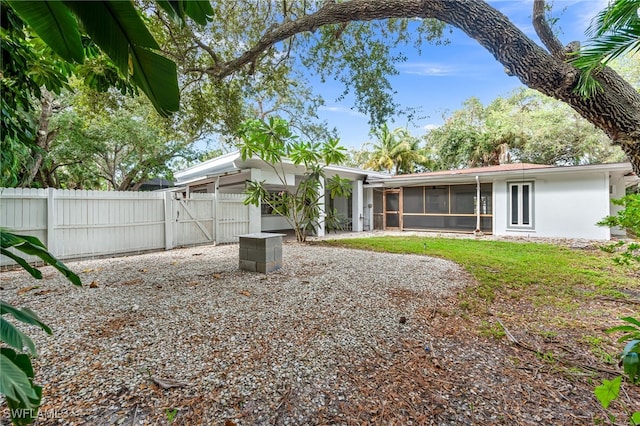 2472 Harbor Rd, Naples, FL 34104 - back of house with a gate and a sunroom