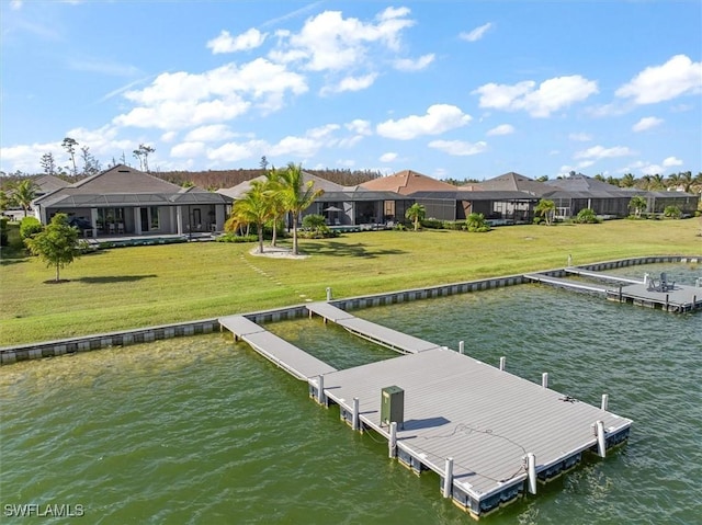 dock area with a lawn and a water view