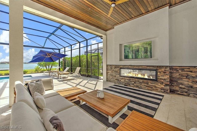 view of patio featuring a lanai and an outdoor living space with a fireplace