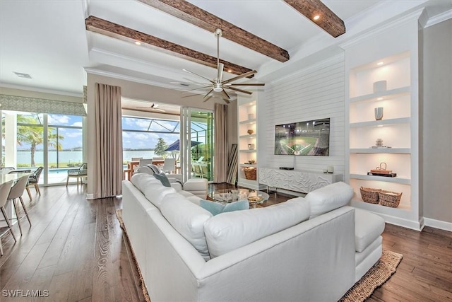 living room with crown molding, ceiling fan, beam ceiling, built in shelves, and dark hardwood / wood-style floors