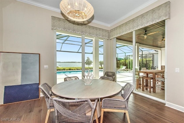 dining space with ceiling fan, ornamental molding, plenty of natural light, and dark hardwood / wood-style flooring