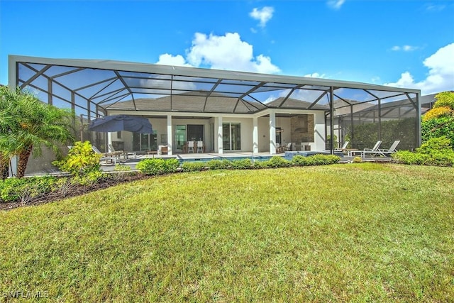 back of property featuring glass enclosure, a yard, and a patio