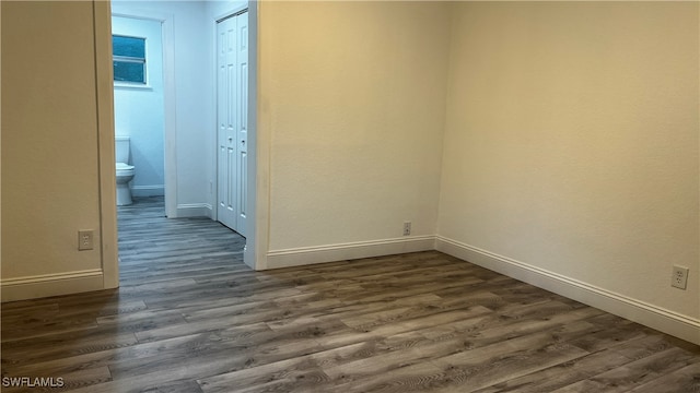 empty room with dark wood-type flooring