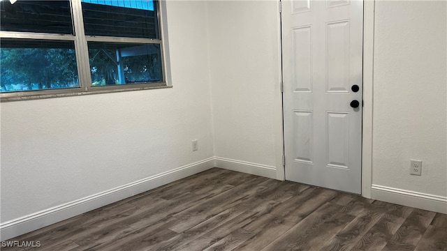 empty room with dark hardwood / wood-style floors