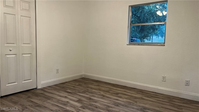 unfurnished bedroom with dark wood-type flooring