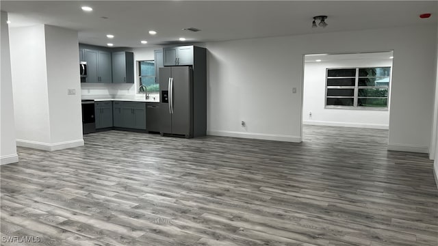 kitchen featuring gray cabinetry, light hardwood / wood-style floors, black appliances, and sink