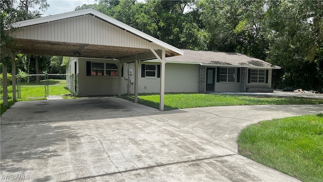 view of front of property with a front lawn and a carport