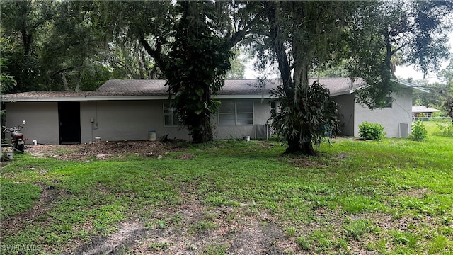 rear view of property featuring a yard