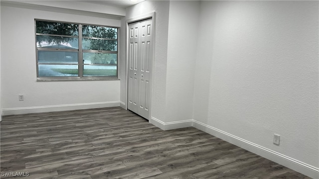 empty room featuring dark wood-type flooring