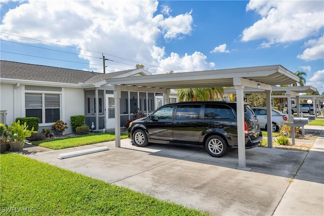 view of parking / parking lot featuring a lawn and a carport