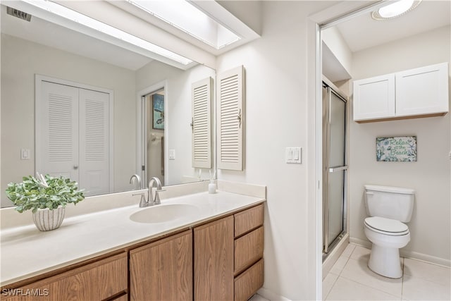 bathroom featuring vanity, a shower with shower door, toilet, and tile patterned floors