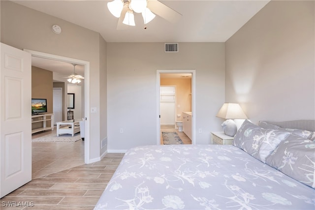 bedroom featuring ceiling fan, light hardwood / wood-style floors, and ensuite bath