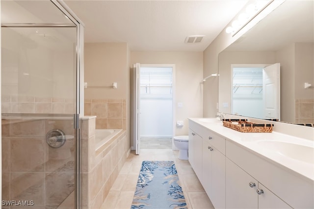 full bathroom featuring plus walk in shower, vanity, toilet, and tile patterned flooring