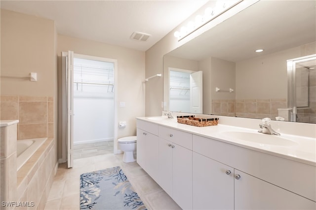 bathroom with toilet, vanity, and tile patterned floors