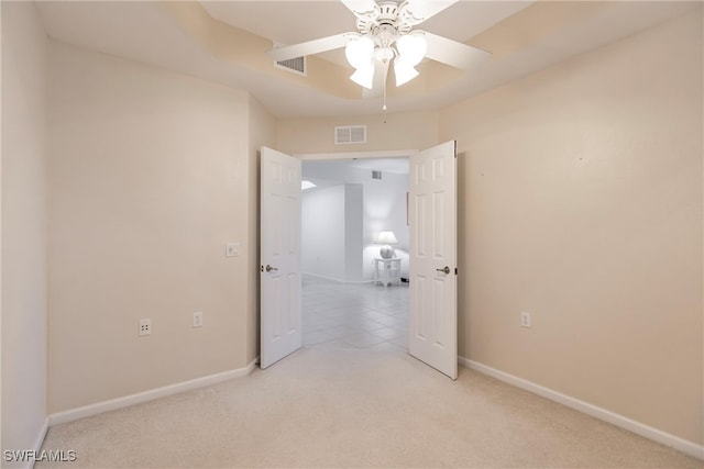 carpeted spare room with ceiling fan