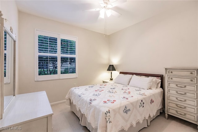 bedroom featuring ceiling fan and light carpet