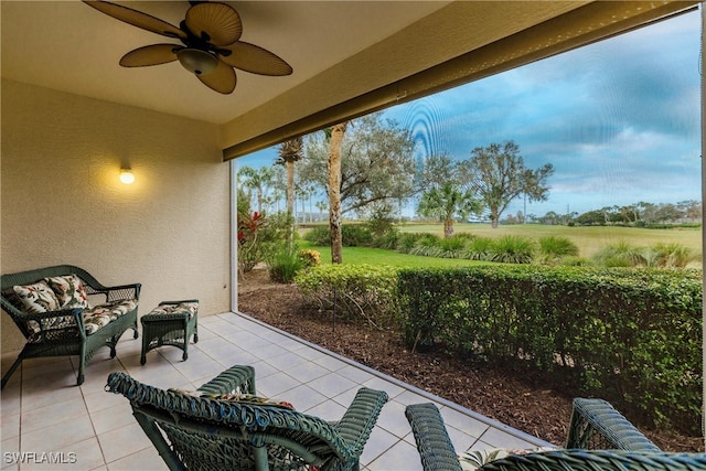 view of patio with a rural view, an outdoor living space, and ceiling fan