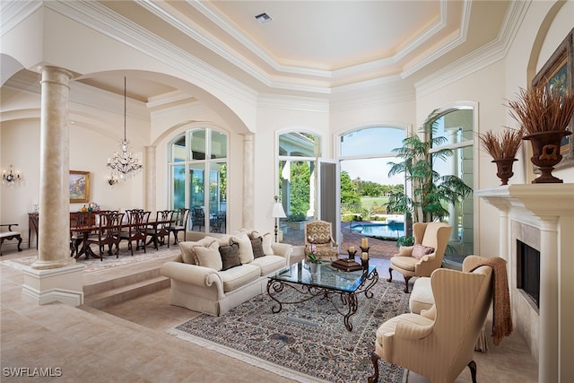 living room featuring ornate columns, a towering ceiling, and ornamental molding