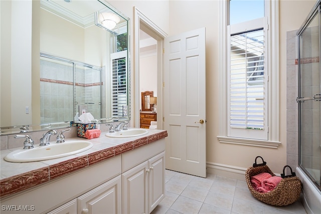 bathroom with vanity, tile patterned flooring, ornamental molding, and plenty of natural light