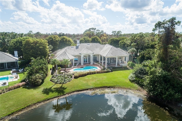 exterior space with a patio, a yard, and a water view