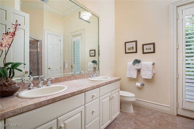 bathroom featuring a shower, toilet, ornamental molding, vanity, and tile patterned flooring