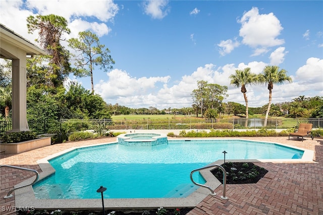 view of swimming pool featuring an in ground hot tub and a patio