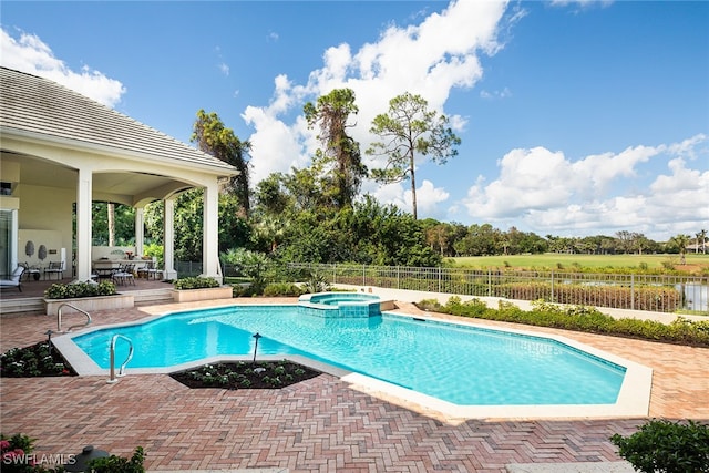 view of swimming pool with an in ground hot tub and a patio area