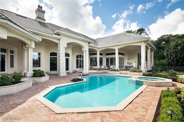 view of swimming pool with an in ground hot tub, a patio, and central AC unit