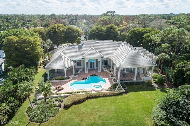 rear view of house with a gazebo, a yard, and a patio