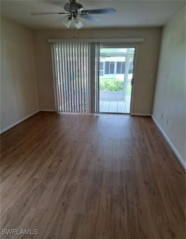 empty room with hardwood / wood-style floors and ceiling fan