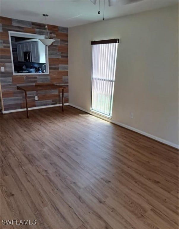 unfurnished living room featuring hardwood / wood-style flooring and ceiling fan