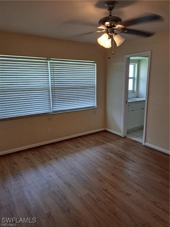 spare room featuring light hardwood / wood-style floors and ceiling fan