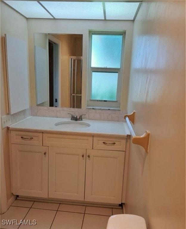 bathroom with vanity, toilet, and tile patterned floors